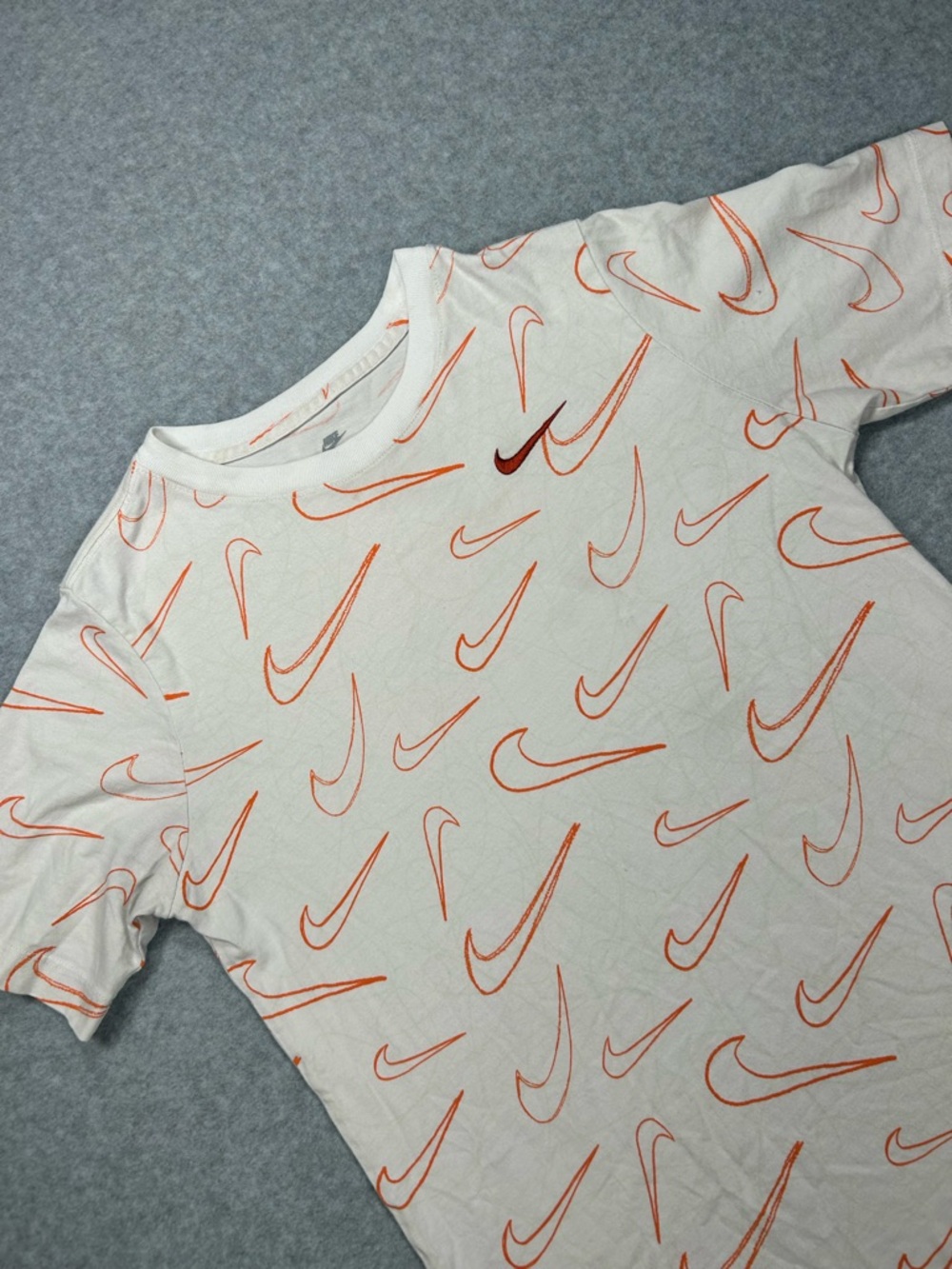 Nike White Tee with Orange All-Over Swoosh Print